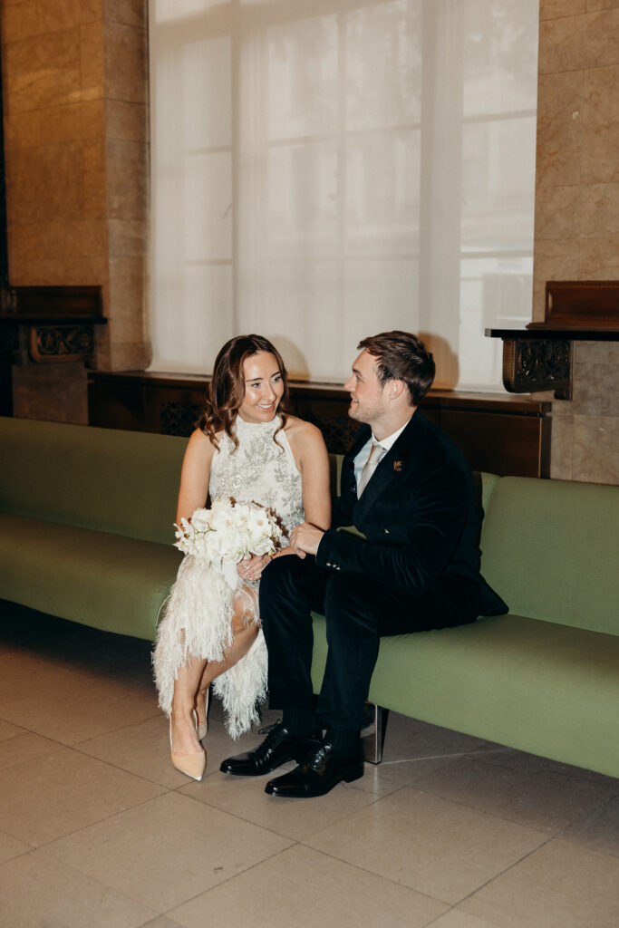 NYC couple sitting on a chair during their NYC City Hall elopement