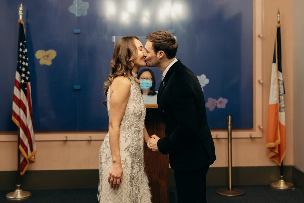 First kiss during elopement ceremony at NYC City Hall