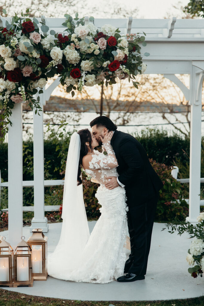 New York couple first kiss at Sea Cliff Manor wedding ceremony