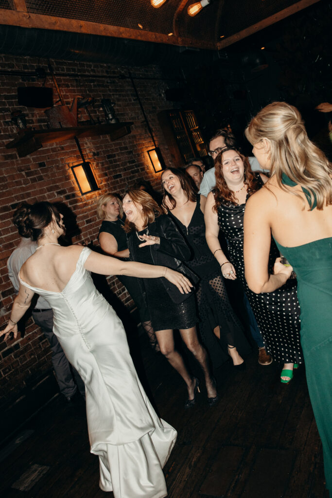Bride and wedding guests dancing at Aurora Williamsburg