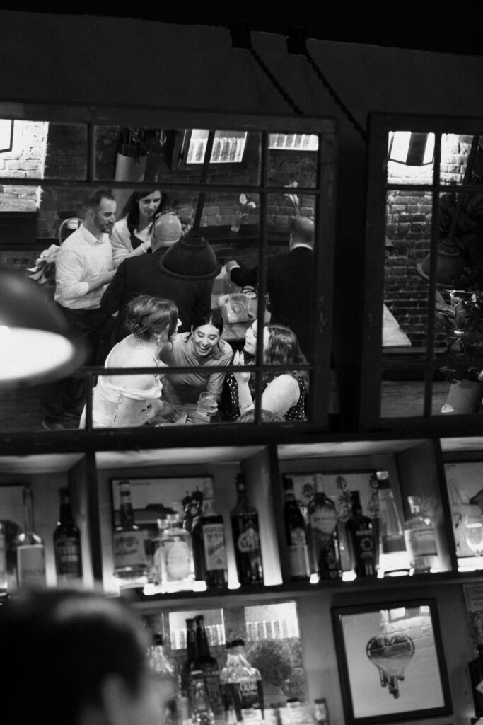 People interacting during dinner at the wedding celebration at Aurora Williamsburg