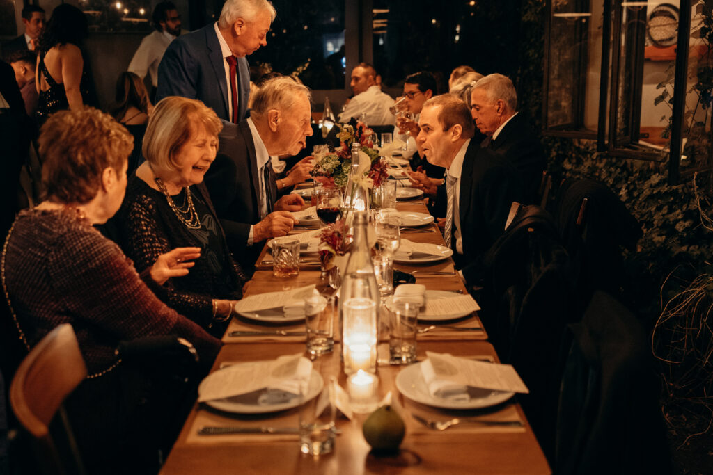 People interacting during dinner at the wedding celebration at Aurora Williamsburg