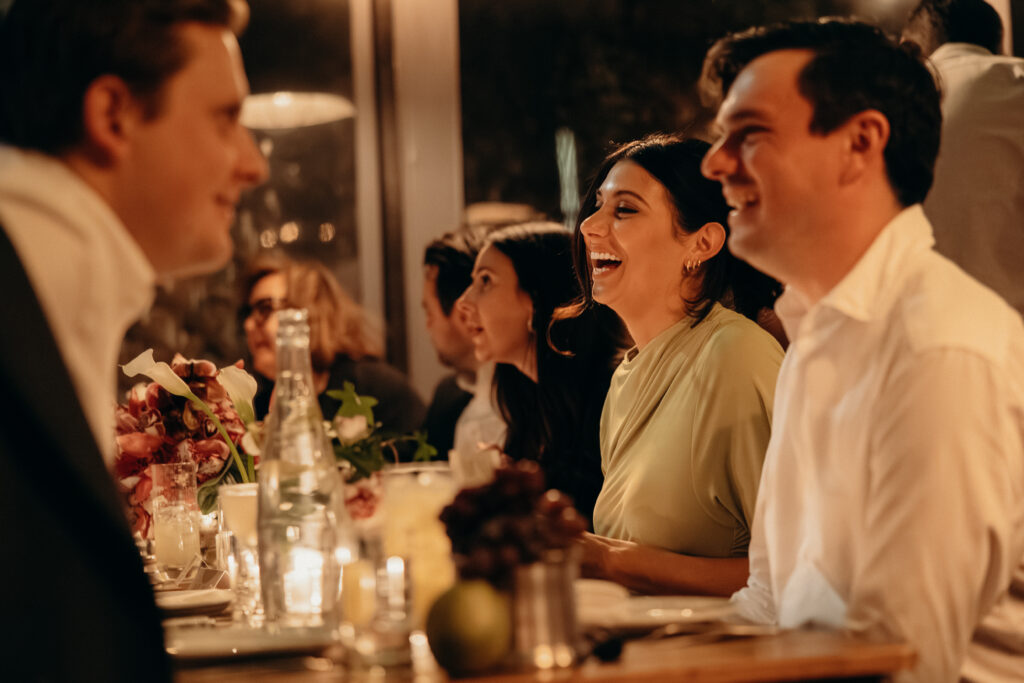People interacting during dinner at the wedding celebration at Aurora Williamsburg