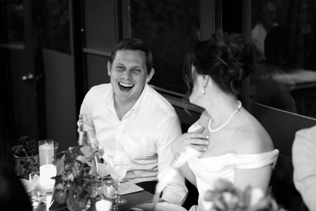 New York couple interacting with guests during dinner at their wedding celebration at Aurora Williamsburg