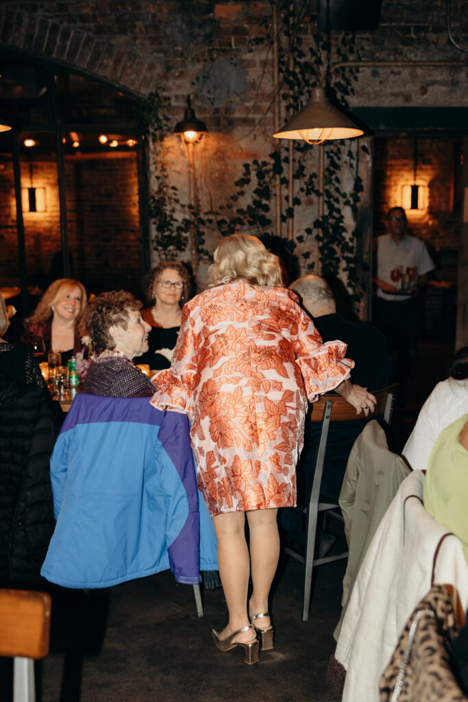 People interacting during dinner at the wedding celebration at Aurora Williamsburg