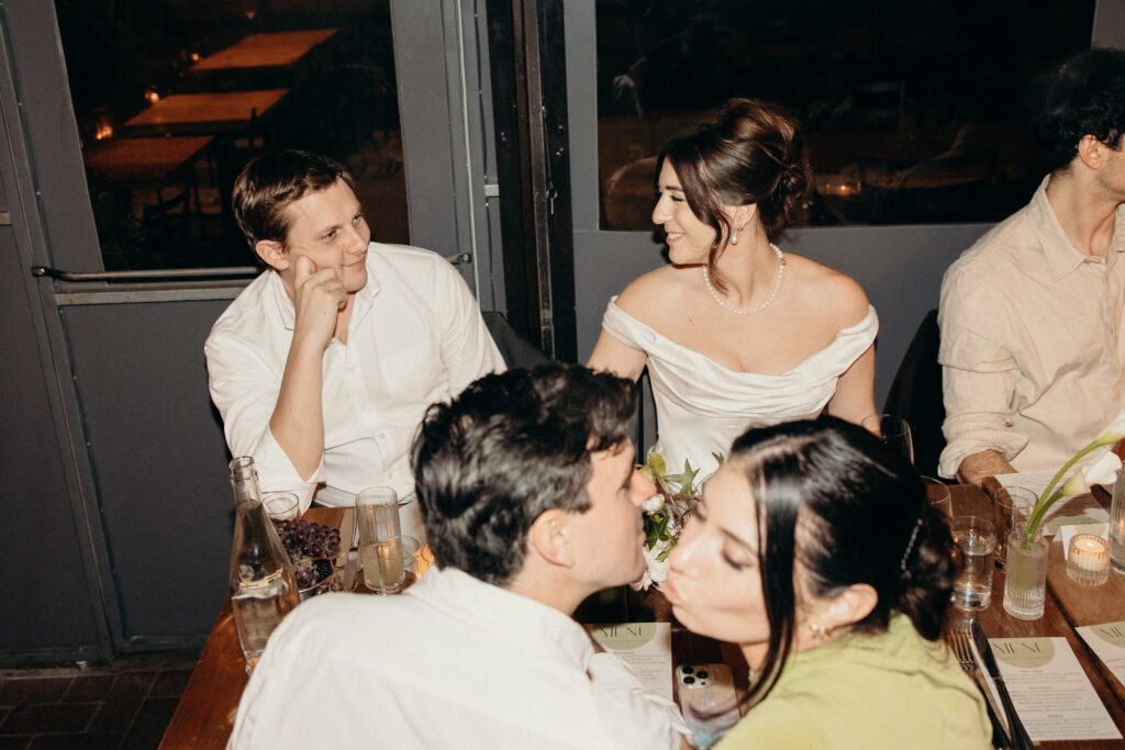 New York couple talking during dinner at their wedding celebration at Aurora Williamsburg