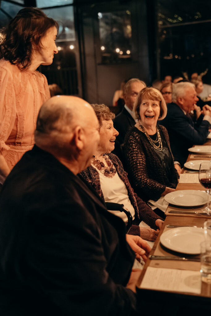 People interacting during dinner at the wedding celebration at Aurora Williamsburg