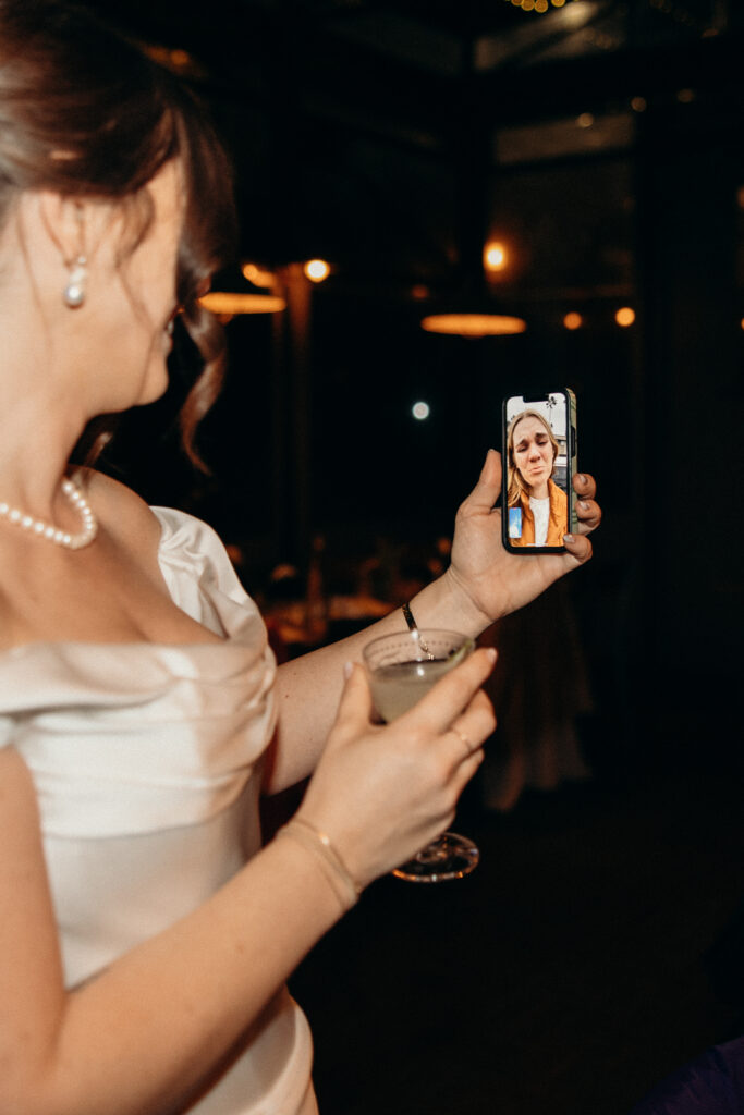 New York bride calling someone on the phone during her wedding celebration at Aurora Williamsburg