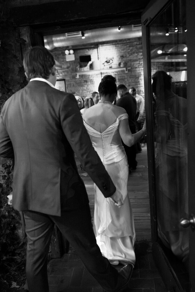 New York couple entering their wedding celebration at Aurora Williamsburg
