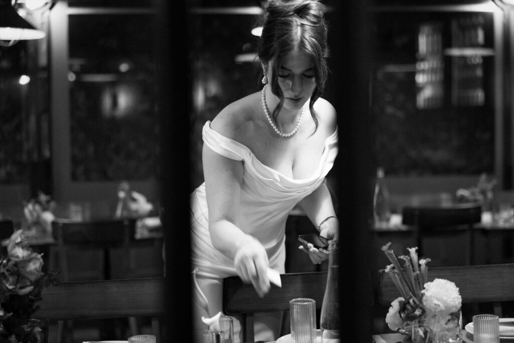 New York bride prepping the table setup for her wedding celebration at Aurora Williamsburg