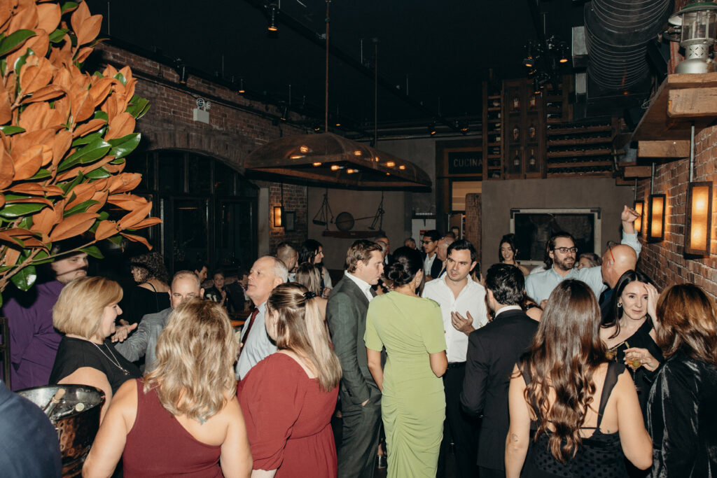 People interacting during dinner at the wedding celebration at Aurora Williamsburg