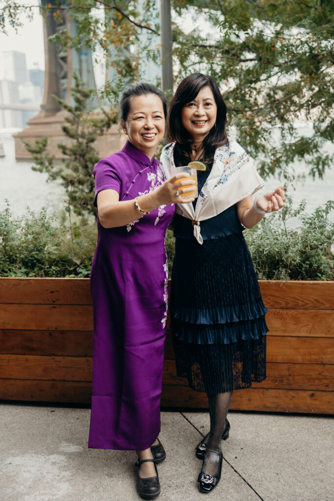 Wedding guests showing off their drinks at a Celestine DUMBO wedding reception