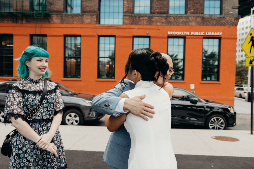 Brooklyn bride hugging guests at a Celestine DUMBO wedding reception