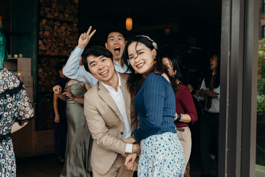 Wedding guests pose for a picture at a Celestine DUMBO wedding reception 