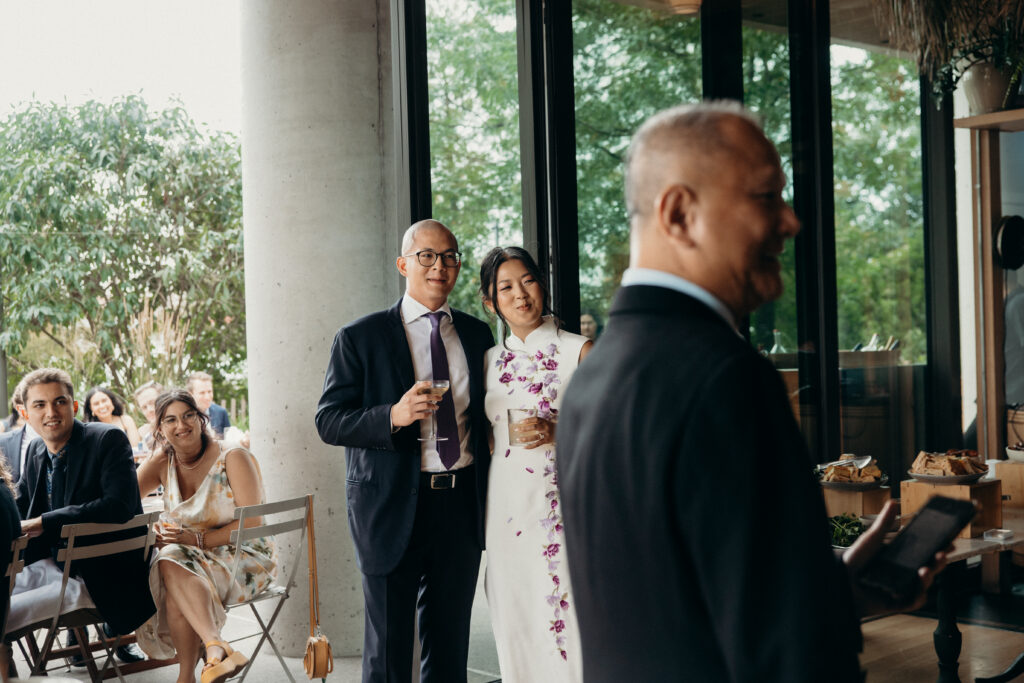 Brooklyn couple holding wedding drinks at a Celestine DUMBO wedding reception 