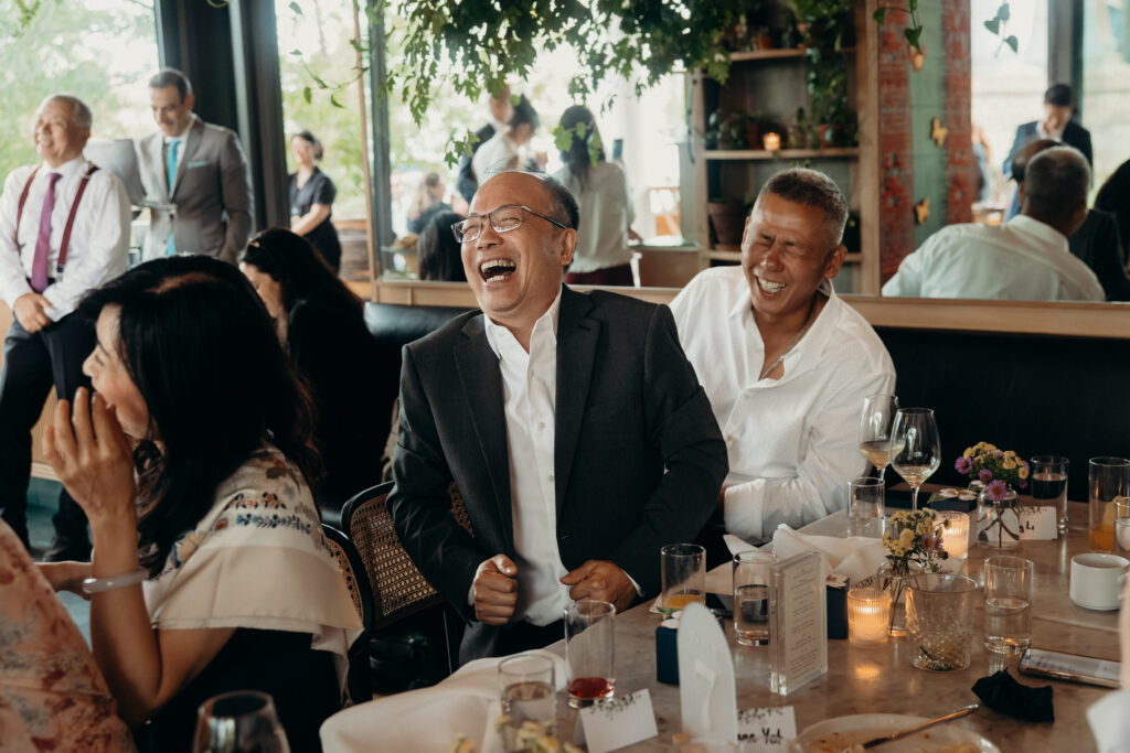 Wedding guests laughing at a Celestine DUMBO wedding reception 