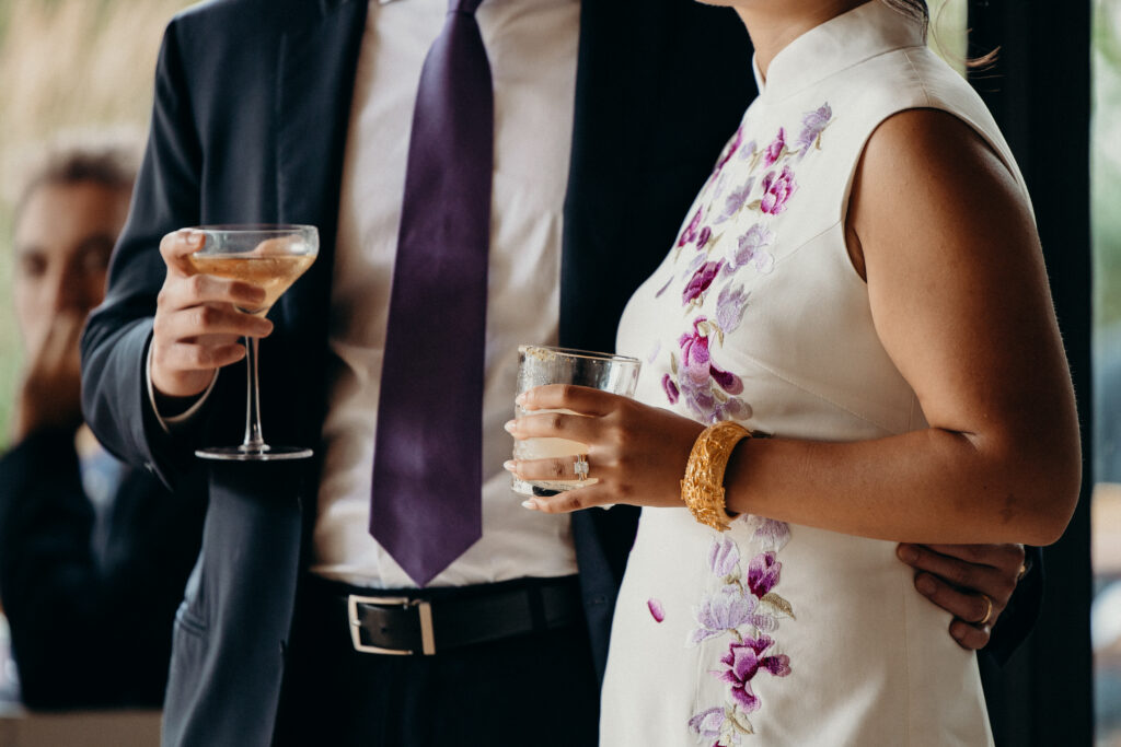 Brooklyn couple holding wedding drinks at a Celestine DUMBO wedding reception 
