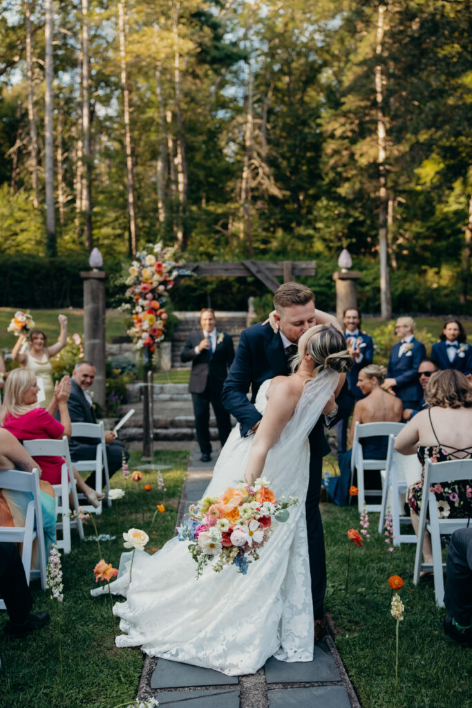 New York couple kissing down the aisle at Arrow Park wedding ceremony