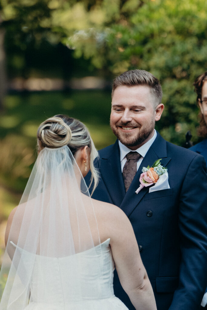 New York groom smiling at Arrow Park wedding ceremony