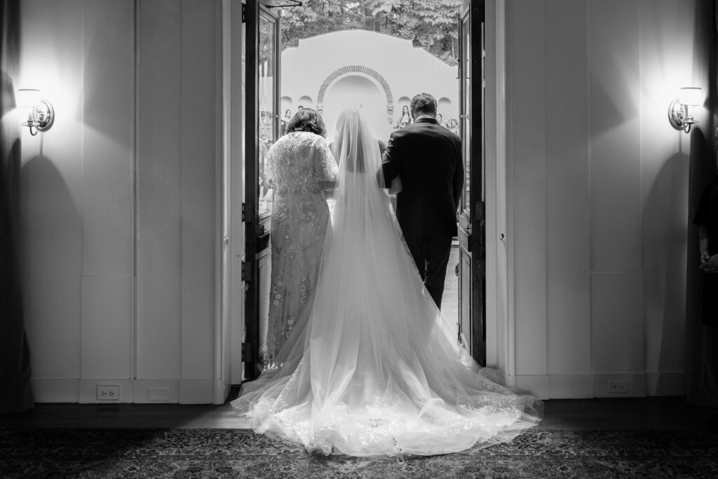 New York bride walking down the aisle with her parents at The Willows wedding ceremony