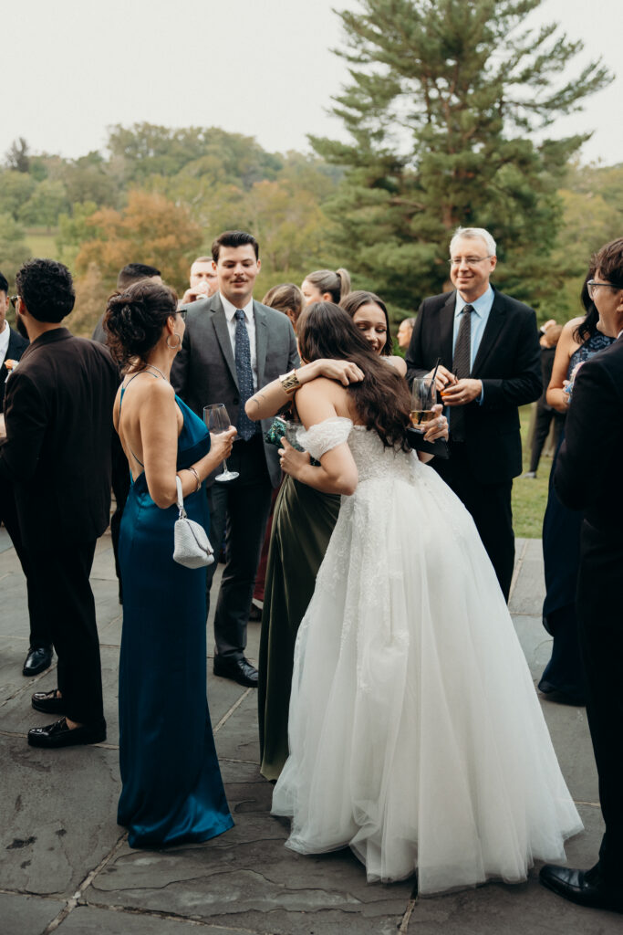 New York bride hugging guests at The Willows wedding cocktail hour