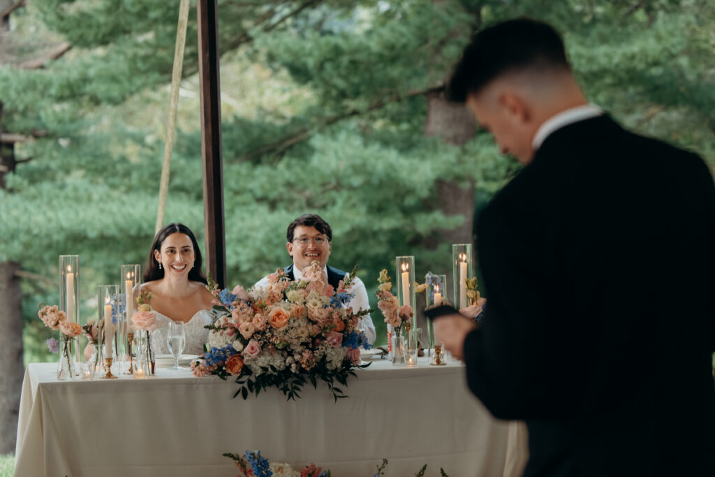 New York groom listening to wedding speeches at The Willows reception