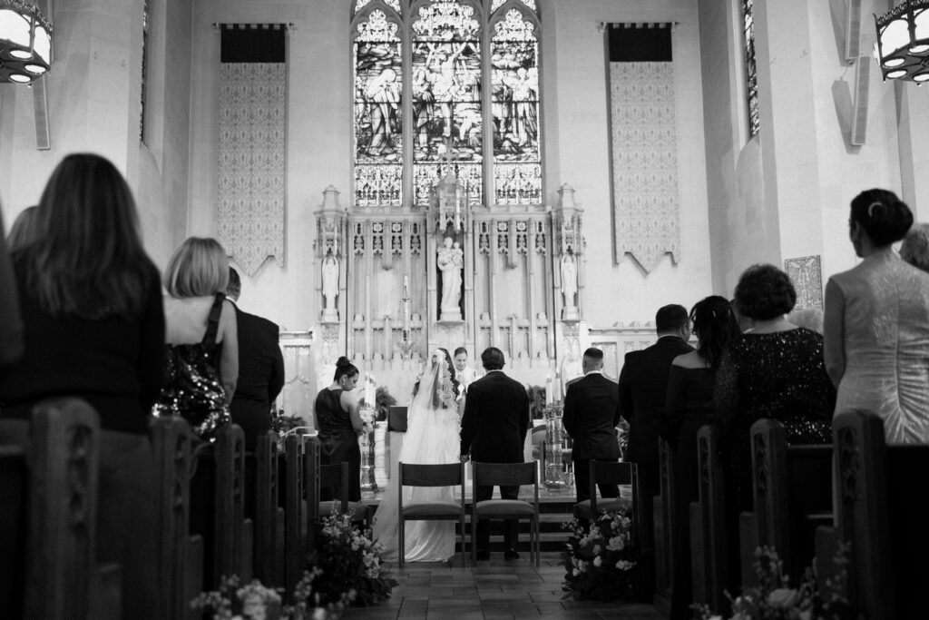 Groom and wedding guests standing at a New York church wedding