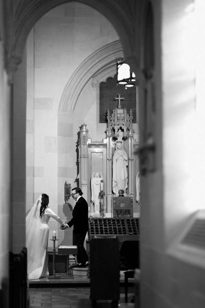Groom guiding the bride at the altar at a New York church wedding