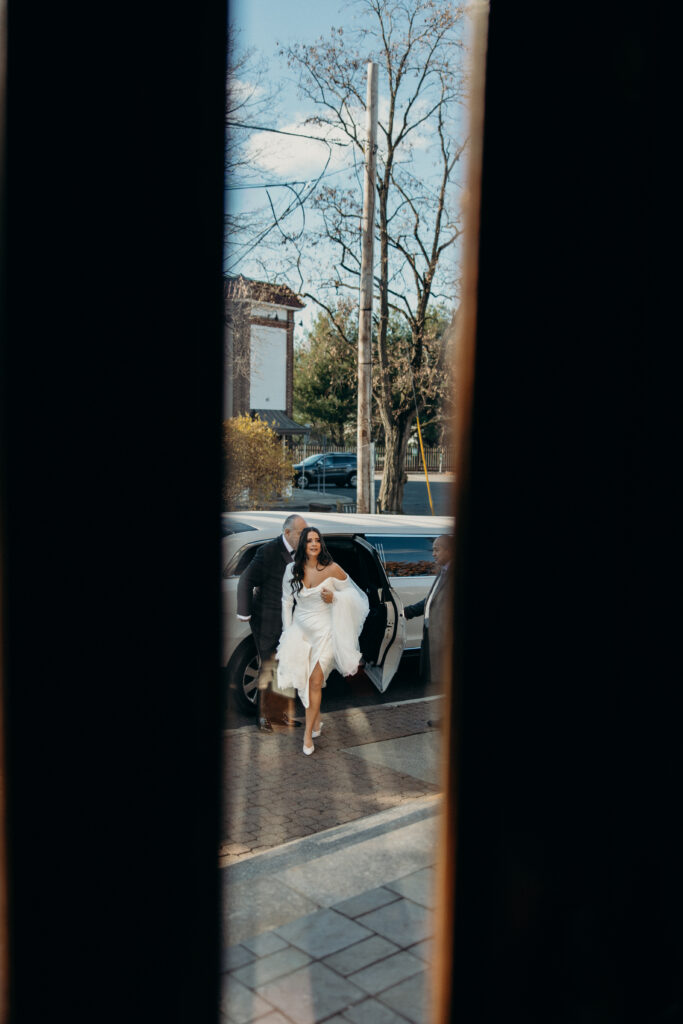 Bride arrives at the wedding ceremony venue at a New York church wedding
