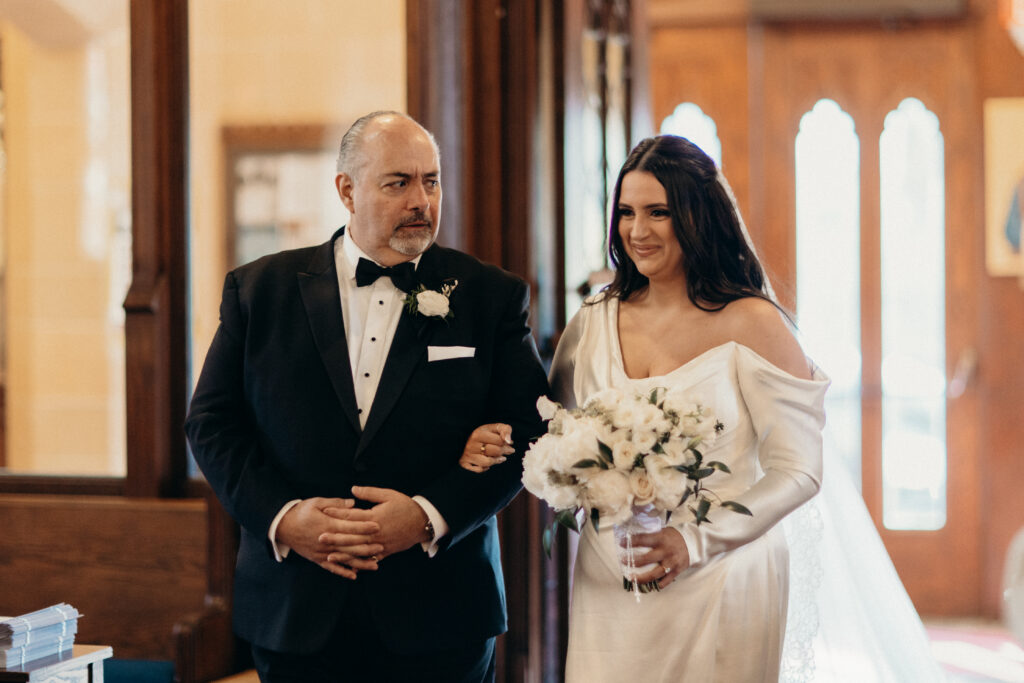 Bride walking down the aisle with dad at a New York church wedding