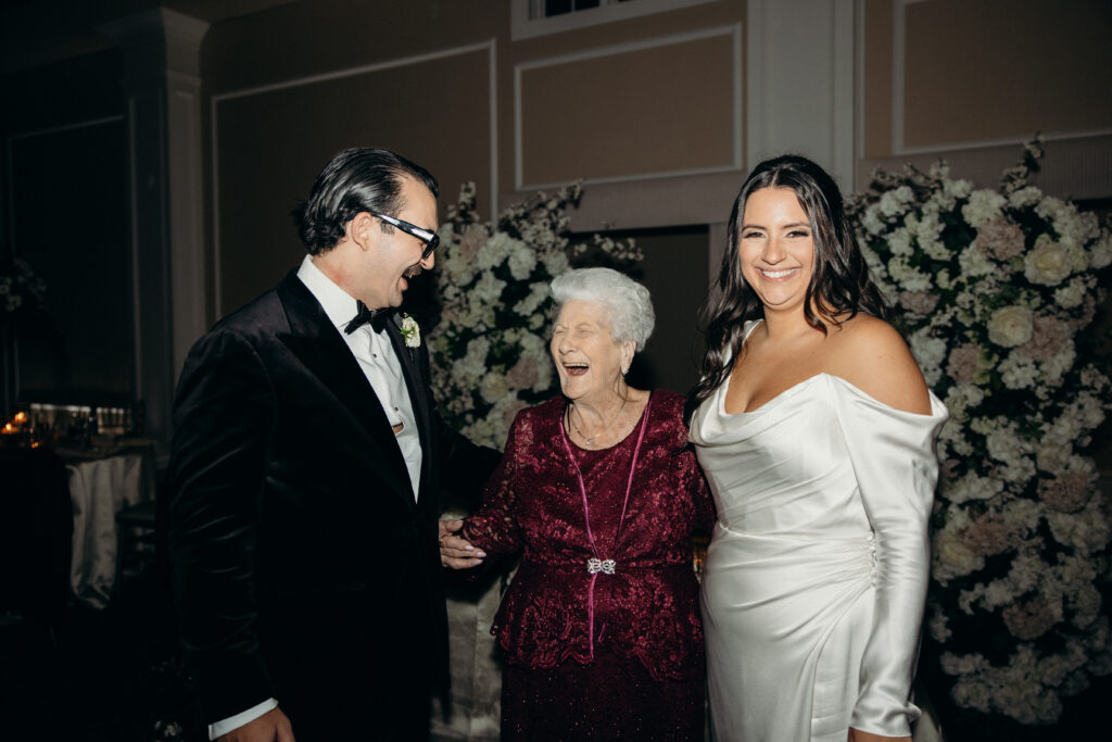 Couple with grandmother during wedding reception at Le Chateau New York