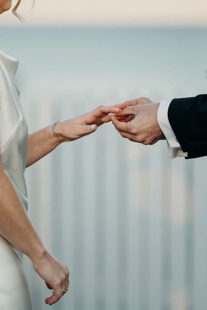 Bride and groom exchanging wedding rings at The Asbury Hotel wedding ceremony