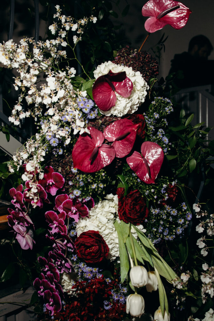 Close-up of red and white wedding floral arrangement installation