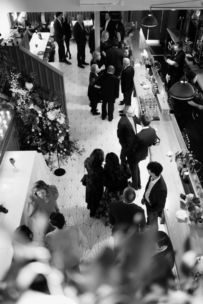 Guests mingling at bar during Madeline’s Brooklyn wedding reception
