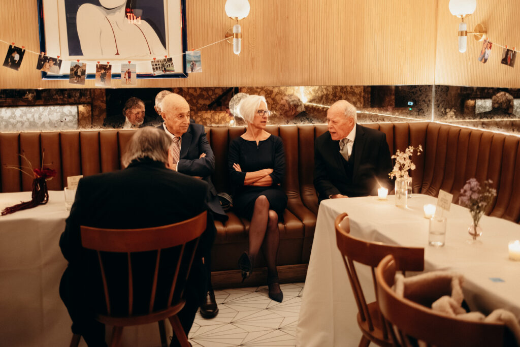 Wedding guests seated and chatting in cozy reception space