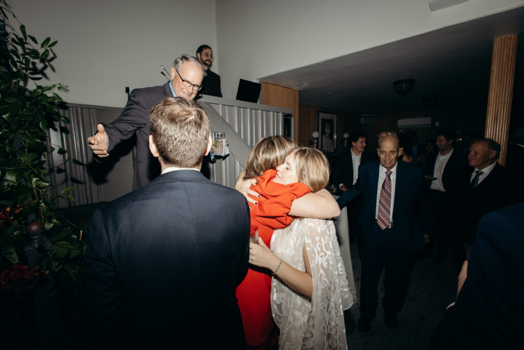 Emotional hugs shared between guests during wedding celebration