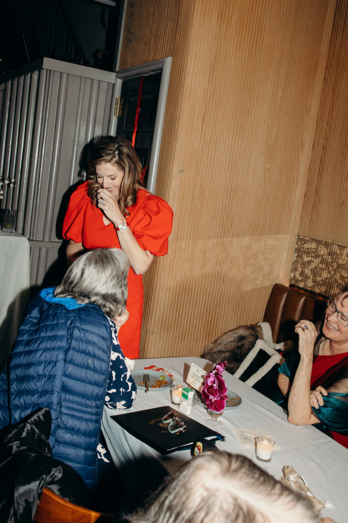 Bride sharing a sweet moment with guests at the table