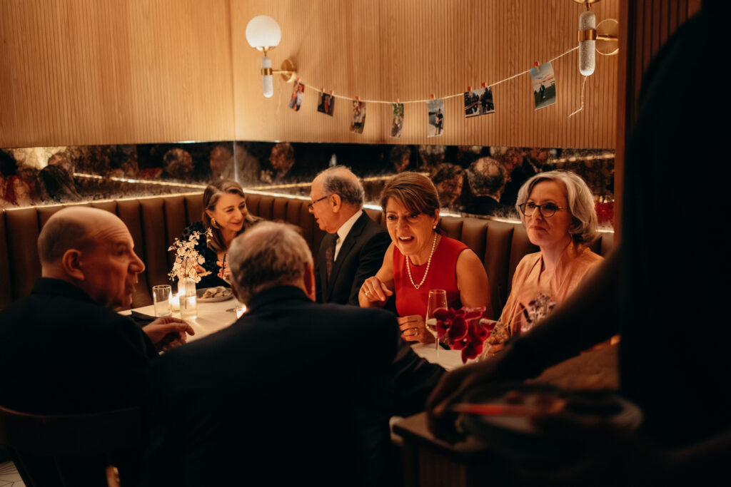 Guests seated and socializing in modern lounge area during wedding reception