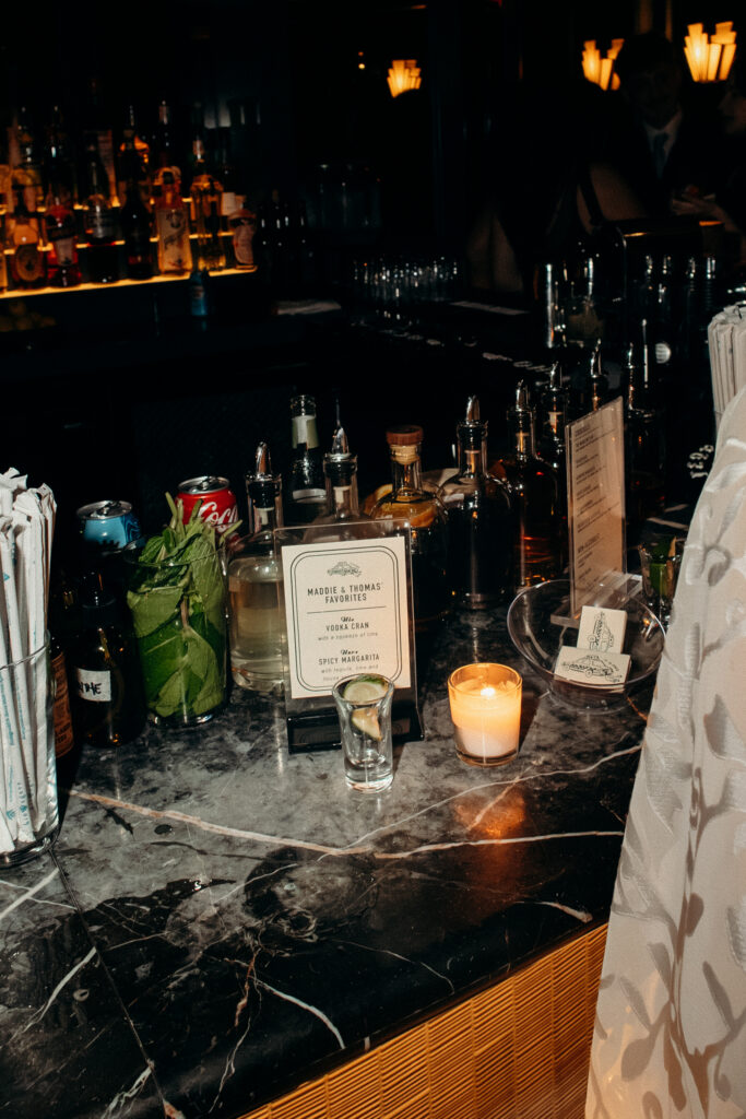 Wedding bar detail with custom drink menu and candlelight ambiance