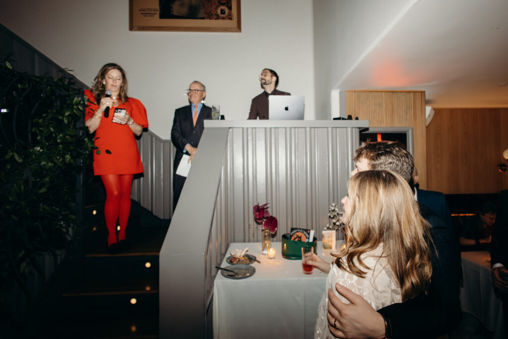 Bride and groom listening to heartfelt speeches during reception