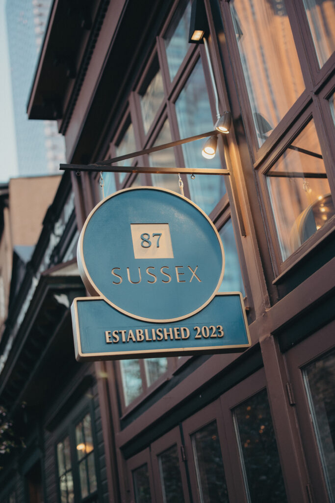 Exterior sign for 87 Sussex restaurant in Jersey City during Sean and Giana’s wedding celebration