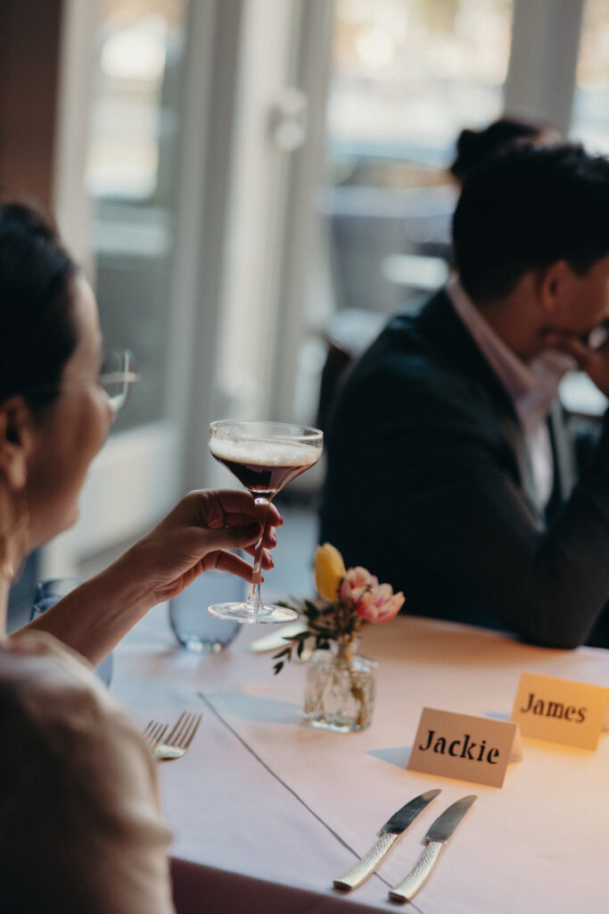 Guest holding an espresso martini during the wedding reception dinner at 87 Sussex