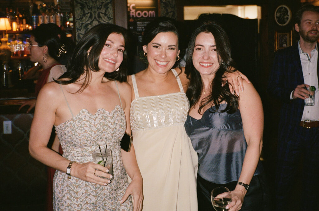 Giana posing with friends at the reception bar during Sean and Giana’s Jersey City elopement celebration