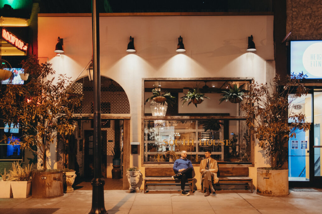 Nighttime exterior of South House in Jersey City with guests sitting outside after Sean and Giana’s elopement celebration