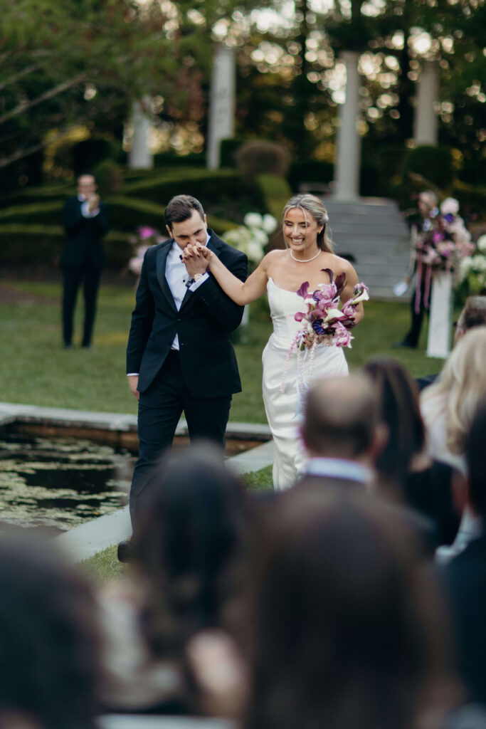 Shay and Kevin walk down the aisle after their ceremony at The Ashford Estate