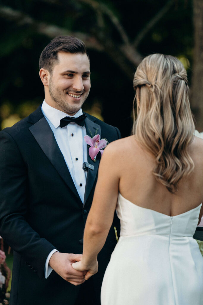 Shay and Kevin hold hands during their outdoor wedding ceremony at The Ashford Estate
