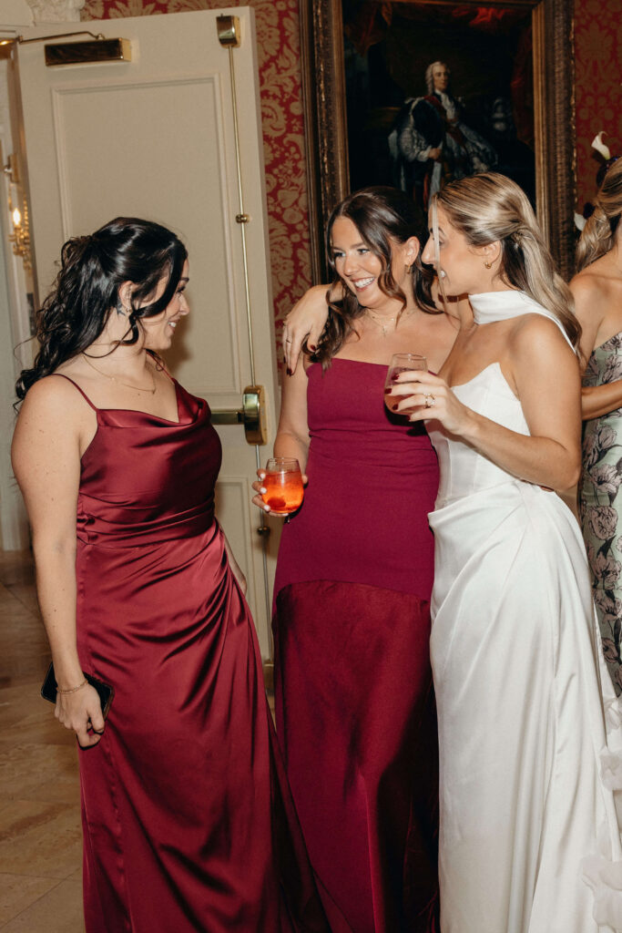 The bride and bridesmaids chatting with drinks during cocktail hour at The Ashford Estate