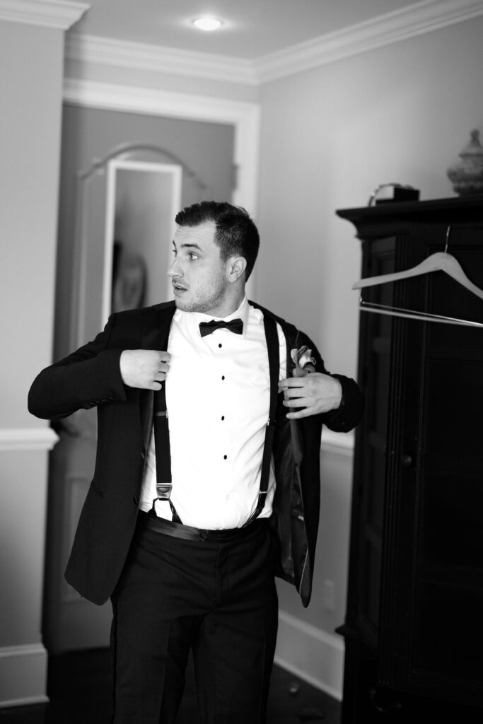 Groom adjusting his tuxedo jacket before the wedding ceremony at The Ashford Estate