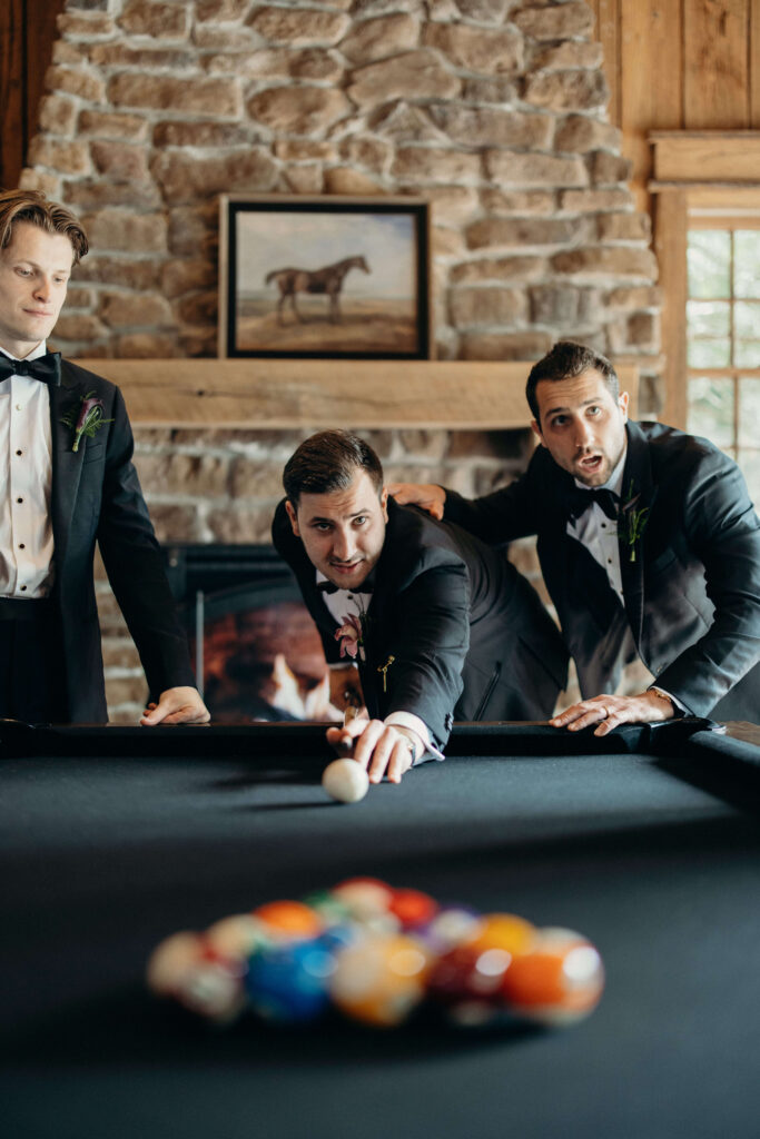 Groomsmen relaxing and playing pool before Shay and Kevin's wedding at The Ashford Estate