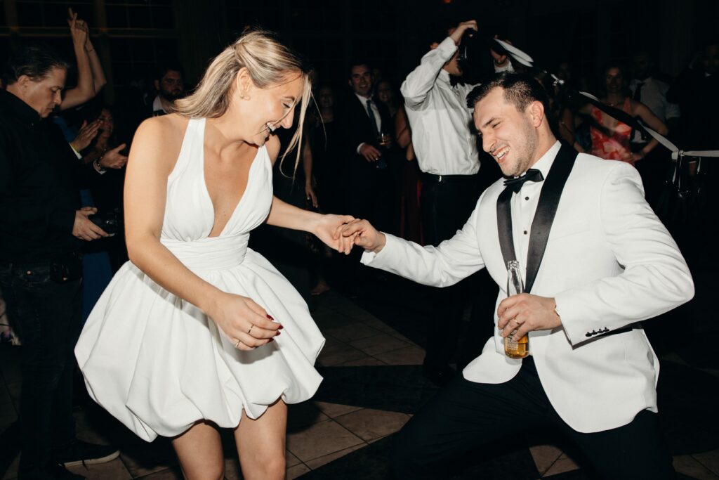 The bride and groom dancing together inside a circle of wedding guests at The Ashford Estate